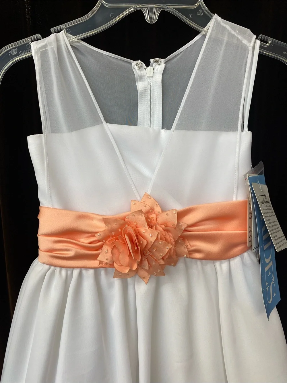 White Girls' Sleeveless Dress with Coral Sash and Floral Accent